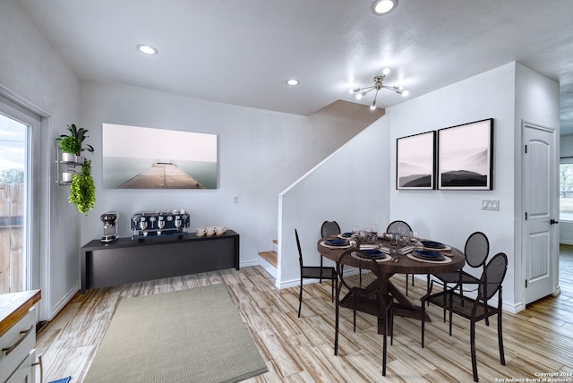 dining area featuring light hardwood / wood-style floors and a chandelier