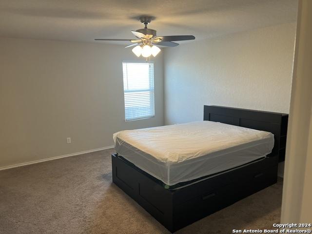 carpeted bedroom featuring ceiling fan