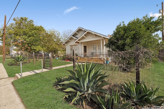 view of front of house with a porch and a front lawn