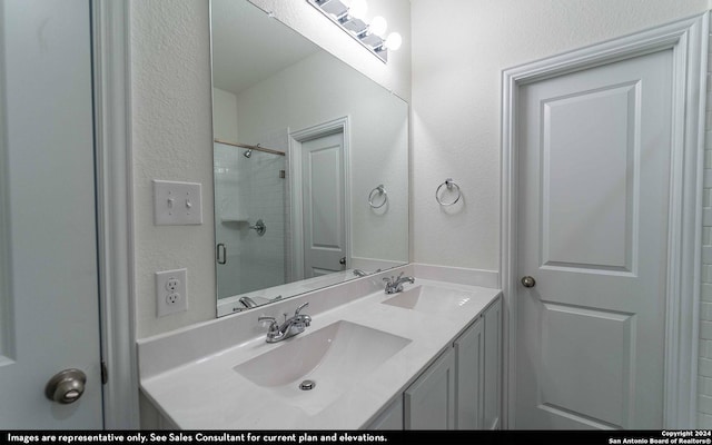 bathroom featuring vanity and an enclosed shower