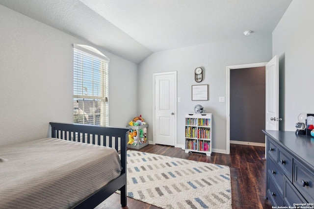 bedroom with dark hardwood / wood-style flooring and vaulted ceiling