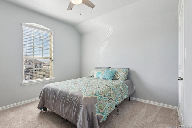 carpeted bedroom featuring vaulted ceiling and ceiling fan