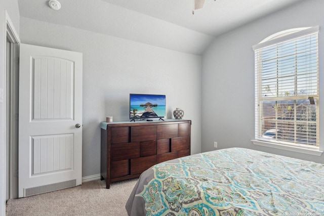 bedroom featuring ceiling fan, light carpet, and vaulted ceiling