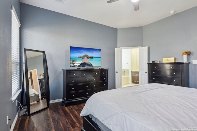 bedroom with multiple windows, ensuite bathroom, ceiling fan, and dark wood-type flooring