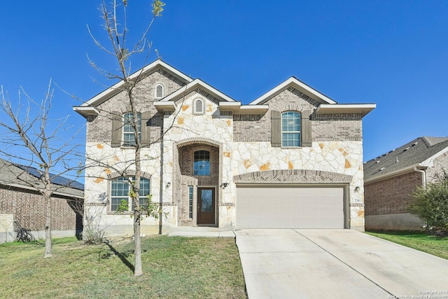 view of front of property with a front yard and a garage