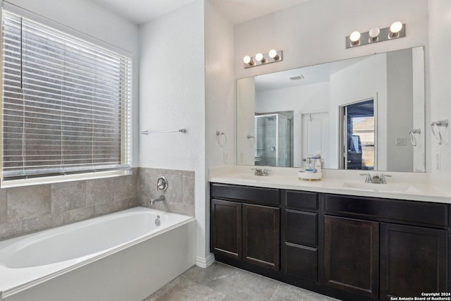 bathroom featuring tile patterned flooring, vanity, and shower with separate bathtub