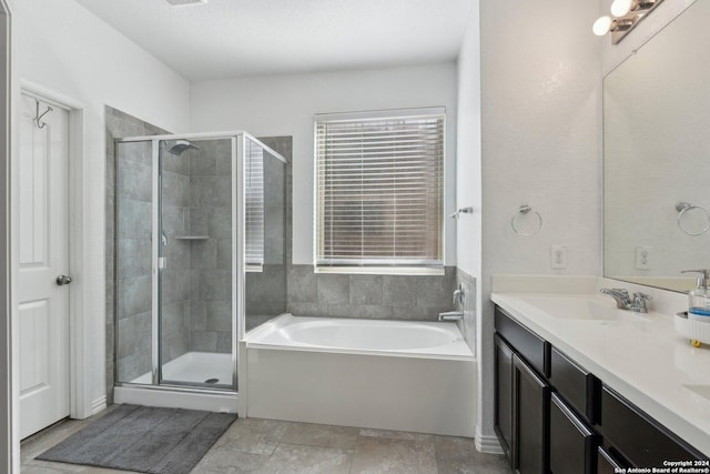 bathroom with vanity and separate shower and tub