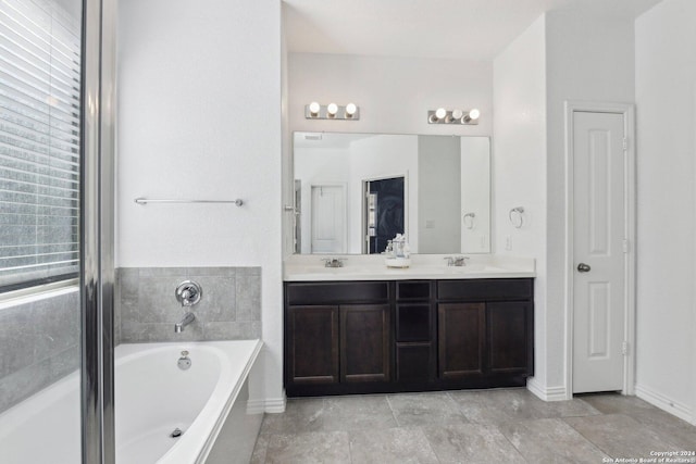 bathroom featuring vanity and a bath