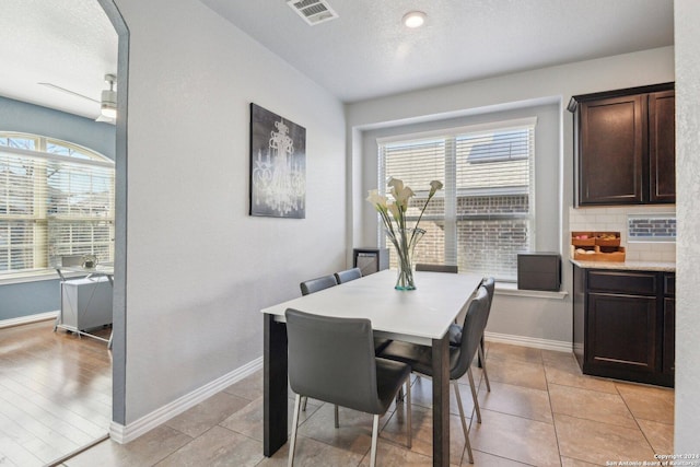 dining area with light tile patterned flooring and a textured ceiling