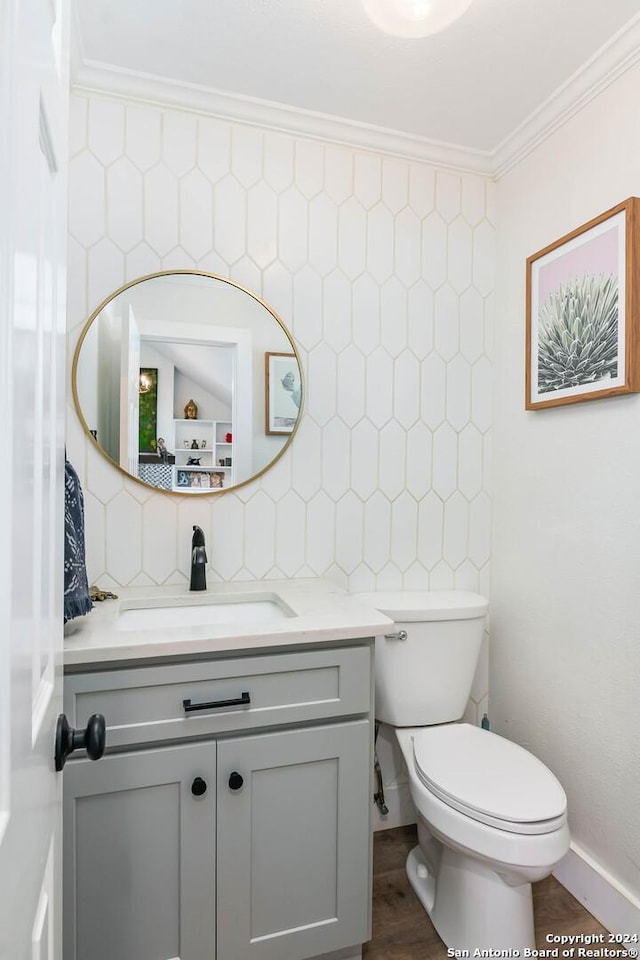 bathroom with vanity, hardwood / wood-style flooring, decorative backsplash, toilet, and ornamental molding