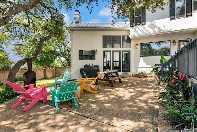 back of property with a patio area and french doors