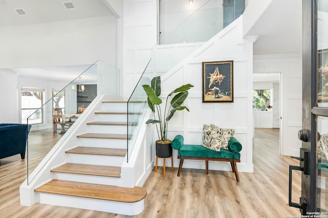 stairs with an inviting chandelier and hardwood / wood-style flooring