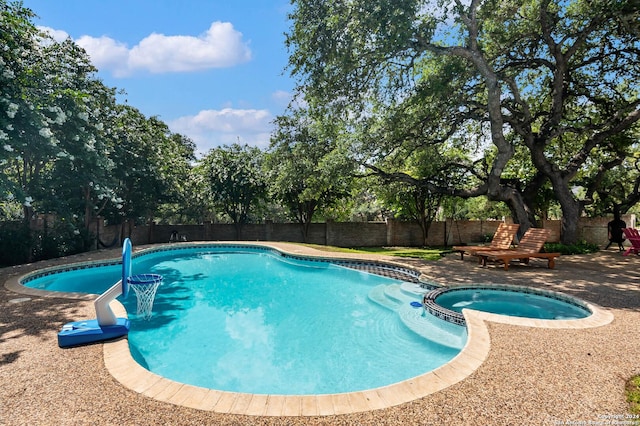 view of swimming pool featuring an in ground hot tub and a patio