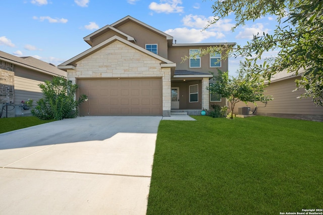 view of front of property with cooling unit, a front yard, and a garage