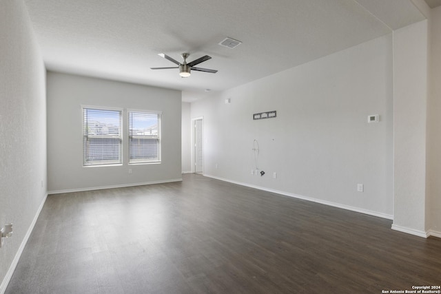 empty room featuring ceiling fan and dark hardwood / wood-style flooring