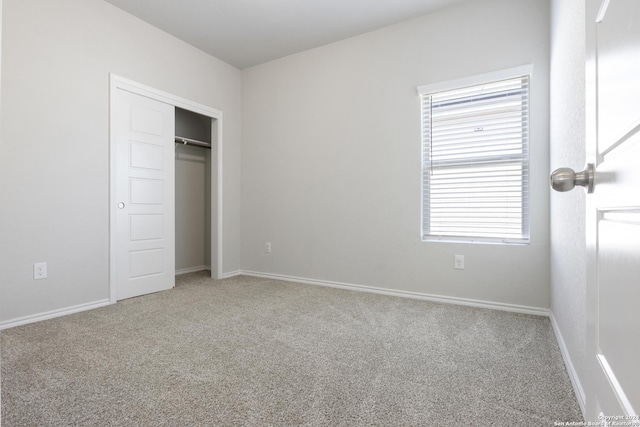 unfurnished bedroom with carpet flooring and a closet