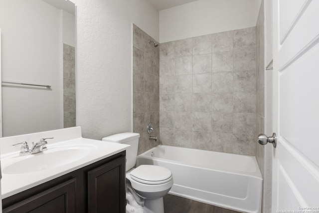 full bathroom with wood-type flooring, vanity, toilet, and tiled shower / bath