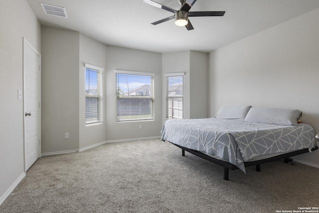 bedroom with ceiling fan and carpet floors