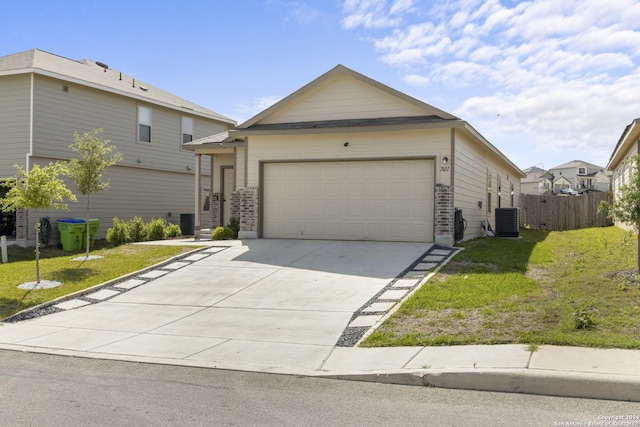 view of front of property with cooling unit, a front yard, and a garage