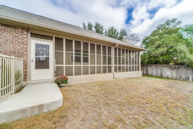 back of property with a sunroom