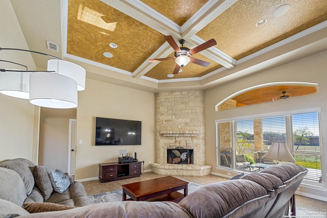 living room featuring coffered ceiling, ceiling fan, ornamental molding, a fireplace, and beamed ceiling