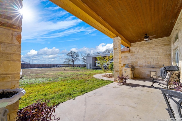 view of patio with ceiling fan and a rural view