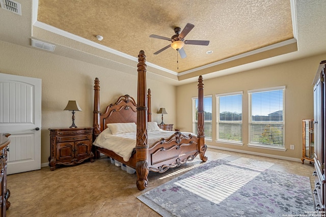 tiled bedroom featuring a raised ceiling, ceiling fan, and ornamental molding