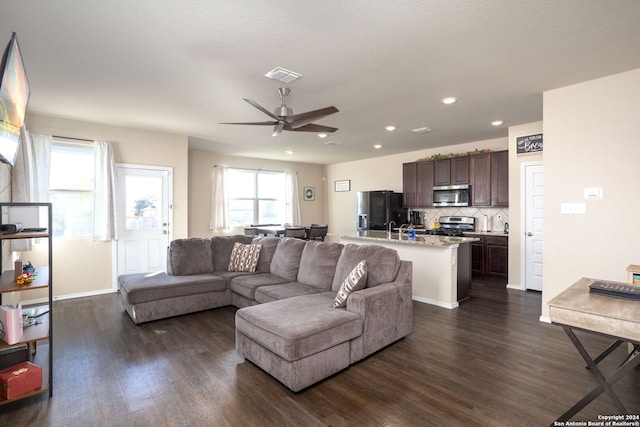 living room featuring dark hardwood / wood-style floors and ceiling fan