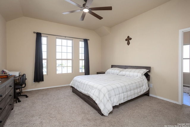 bedroom featuring light colored carpet, vaulted ceiling, and ceiling fan