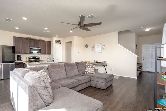 living room with dark hardwood / wood-style floors and ceiling fan