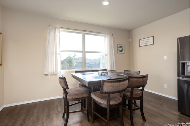 dining space with dark hardwood / wood-style flooring