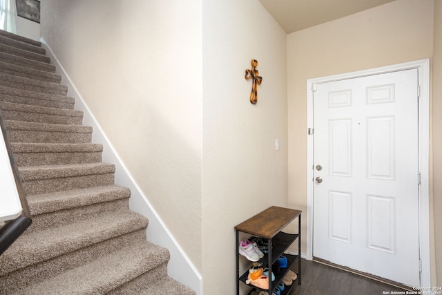 staircase with hardwood / wood-style floors