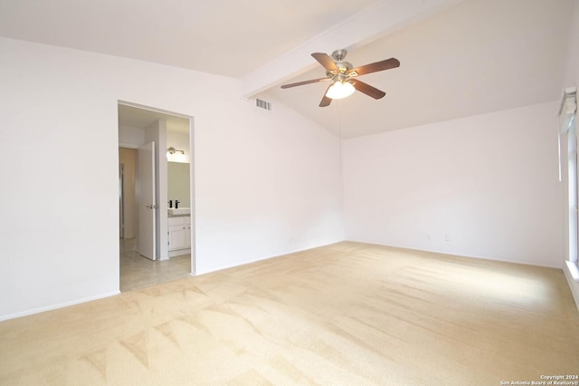 spare room with vaulted ceiling with beams, ceiling fan, and light carpet