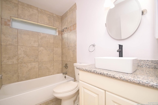 full bathroom with vanity, tiled shower / bath combo, and toilet