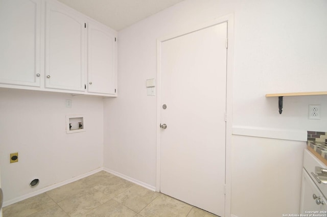 clothes washing area featuring hookup for an electric dryer, light tile patterned flooring, cabinets, and washer hookup