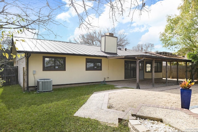 back of property with a lawn, cooling unit, and a patio