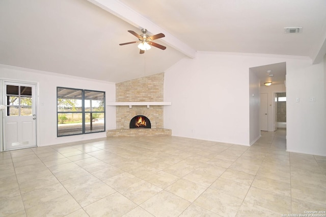 unfurnished living room featuring a fireplace, lofted ceiling with beams, and ceiling fan