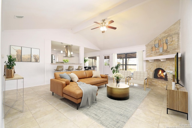 living room featuring vaulted ceiling with beams, ceiling fan, and a brick fireplace