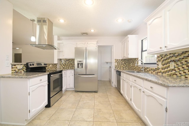 kitchen with white cabinets, appliances with stainless steel finishes, and extractor fan