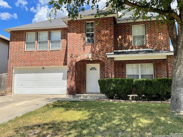 view of front of house featuring a front yard and a garage