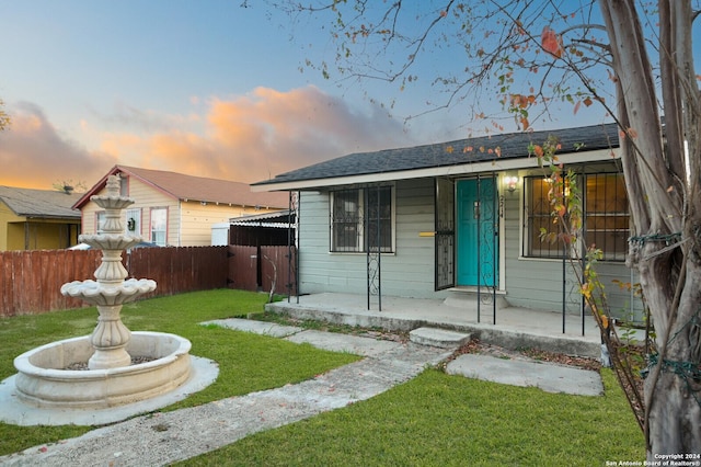 bungalow-style house featuring a lawn and covered porch