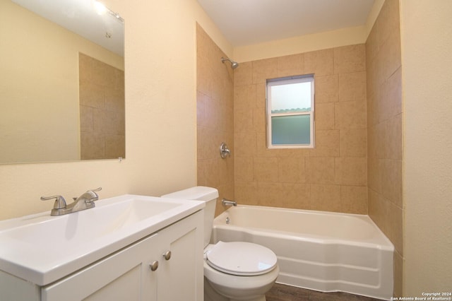 full bathroom with vanity, toilet, and tiled shower / bath