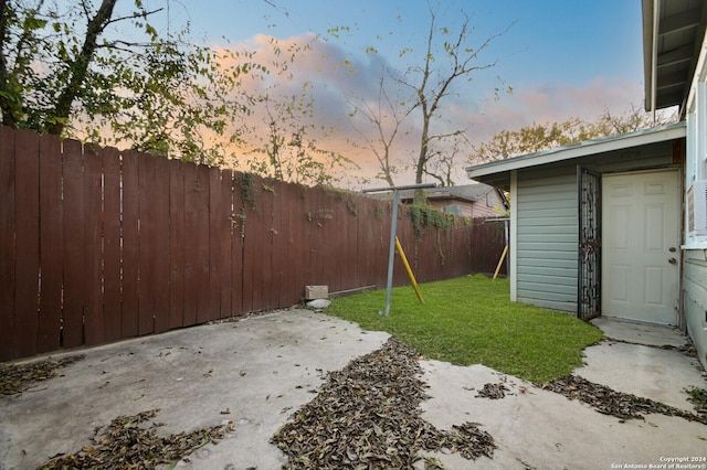 yard at dusk with a playground and a patio