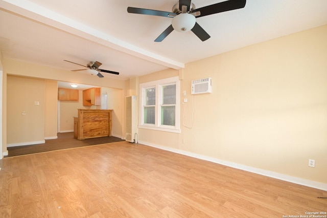 unfurnished living room with ceiling fan, beam ceiling, light wood-type flooring, and a wall unit AC