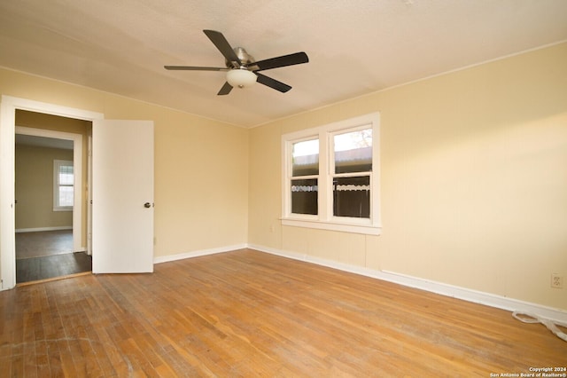 spare room with hardwood / wood-style floors, plenty of natural light, and ceiling fan