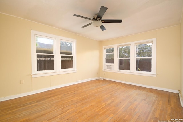 spare room with hardwood / wood-style floors and ceiling fan