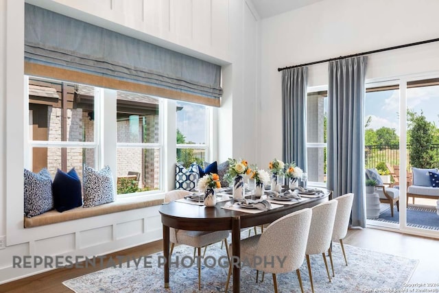 dining area with a wealth of natural light and hardwood / wood-style floors