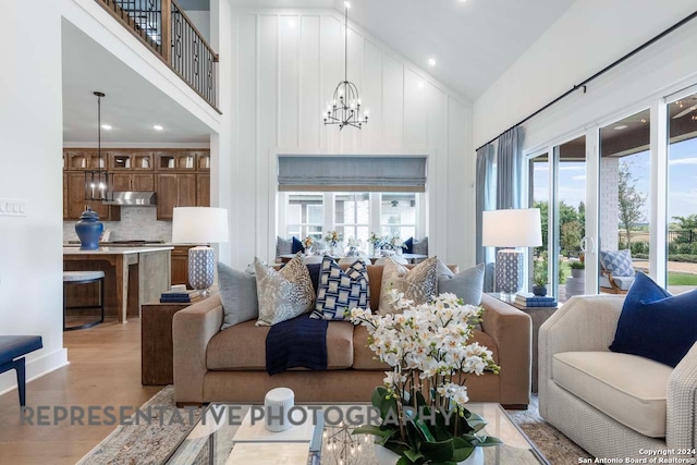 living room featuring high vaulted ceiling and an inviting chandelier