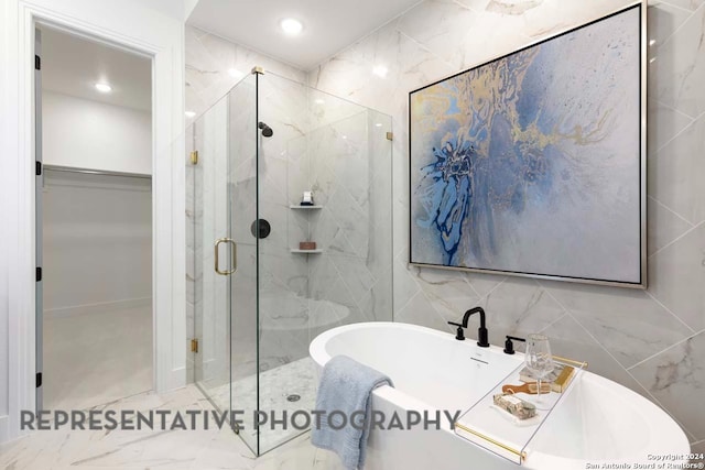 bathroom with separate shower and tub and tile walls