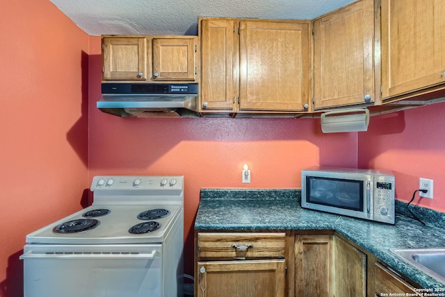 kitchen with sink, white electric range oven, and a textured ceiling